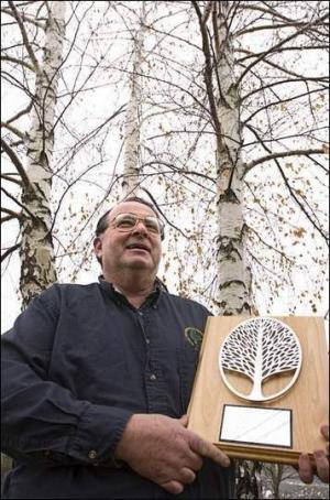 Tom Camberland, Tree Warden, holding award - outside in front of trees