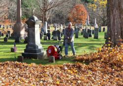 blowing leaves at cemetery