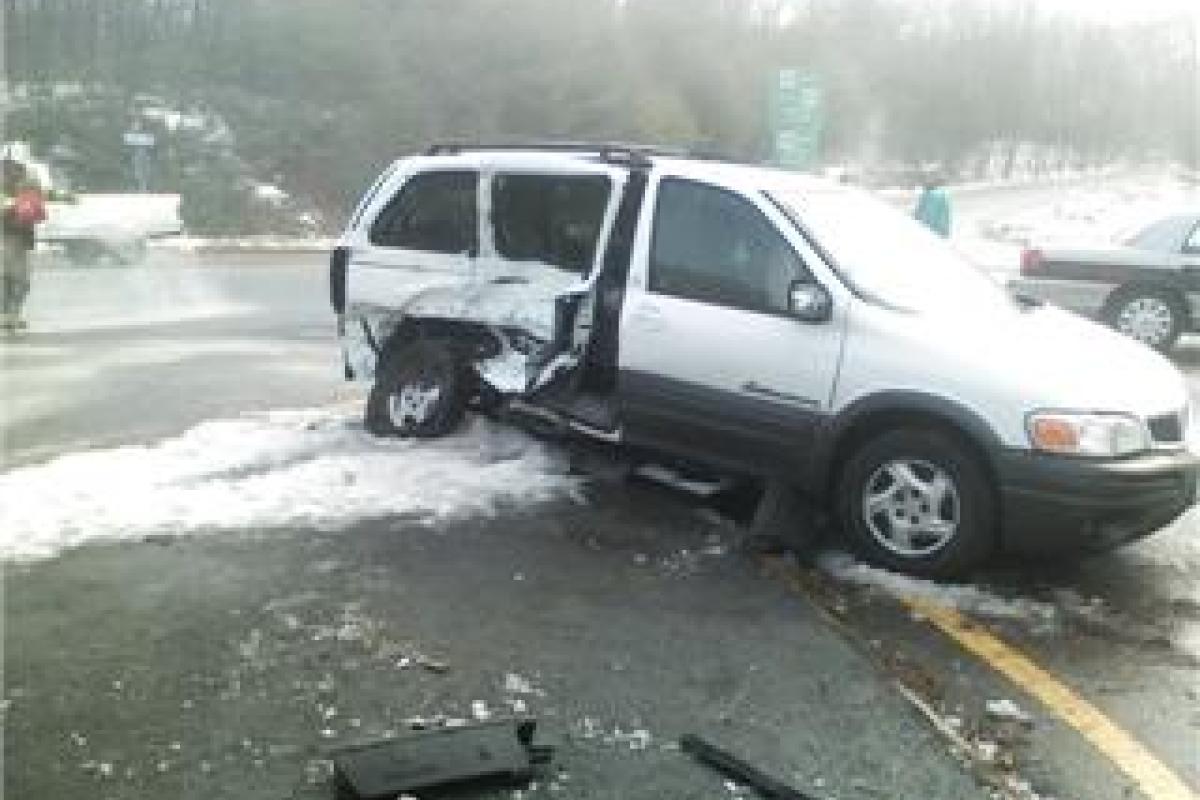 Minivan with damage at schene of accident