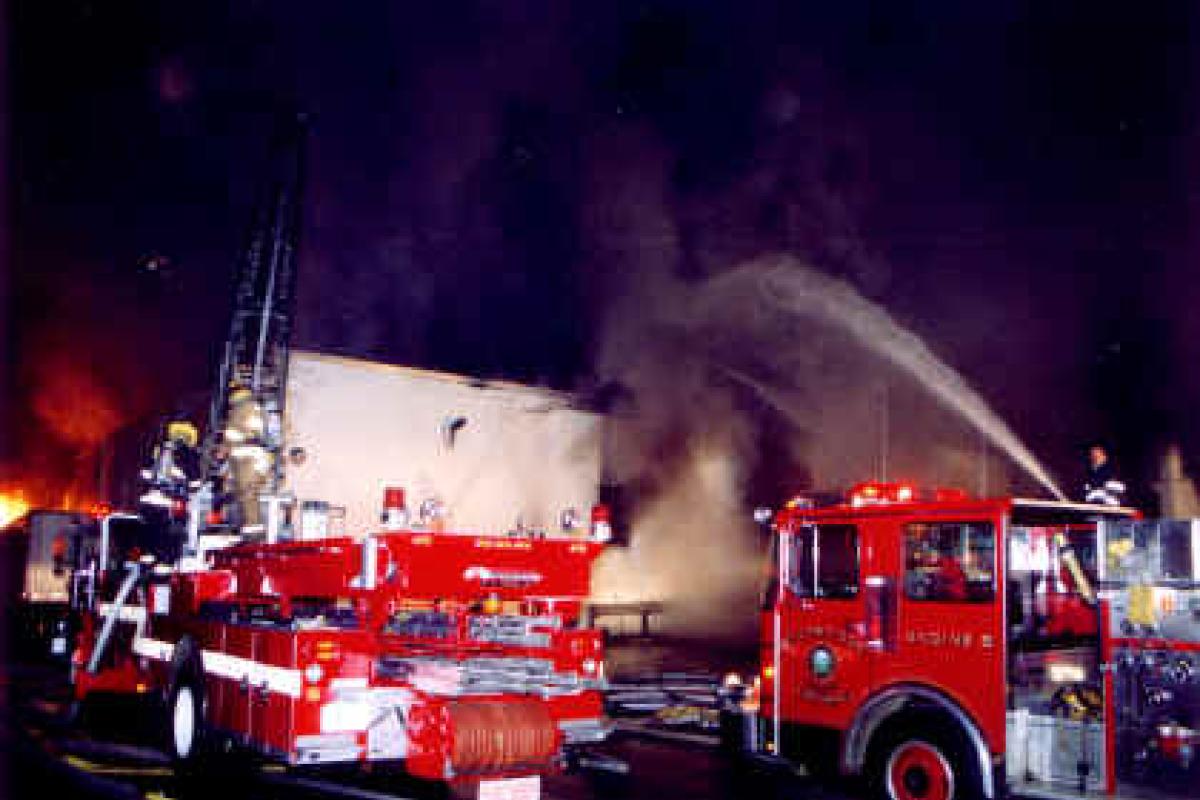 Fire Apparatus shooting a sdtream of water at scene of a fire