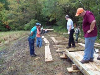 Members of the trail committee construct Bridge 8