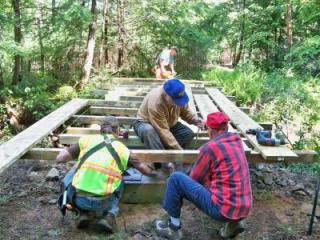 Members of the trail committee construct Bridge 8